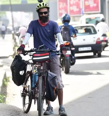 The world is full of goodness for Arun, a tourist on a bicycle